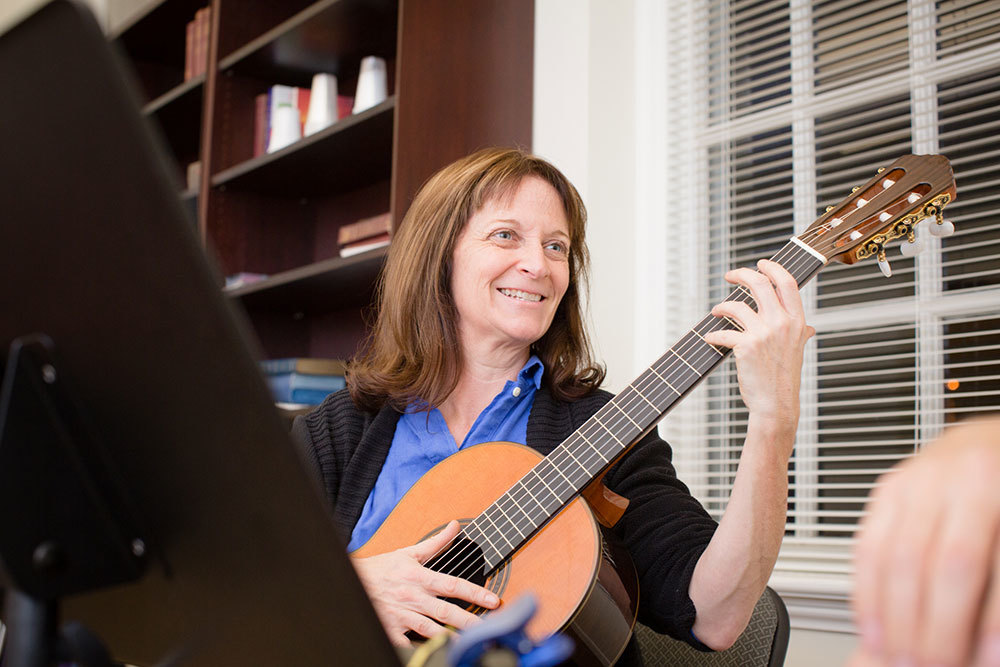 An adult guitar student at Baltimore School of Music.