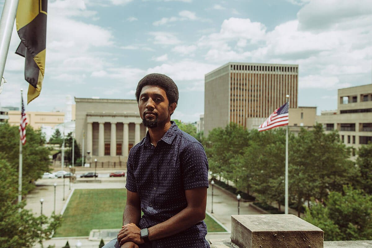 Scott seated outside City Hall.