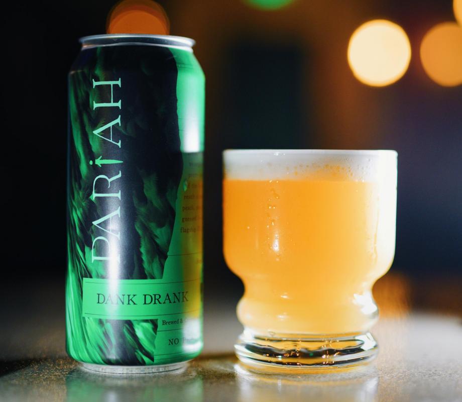 Pariah Brewing Co. beer can next to glass of beer