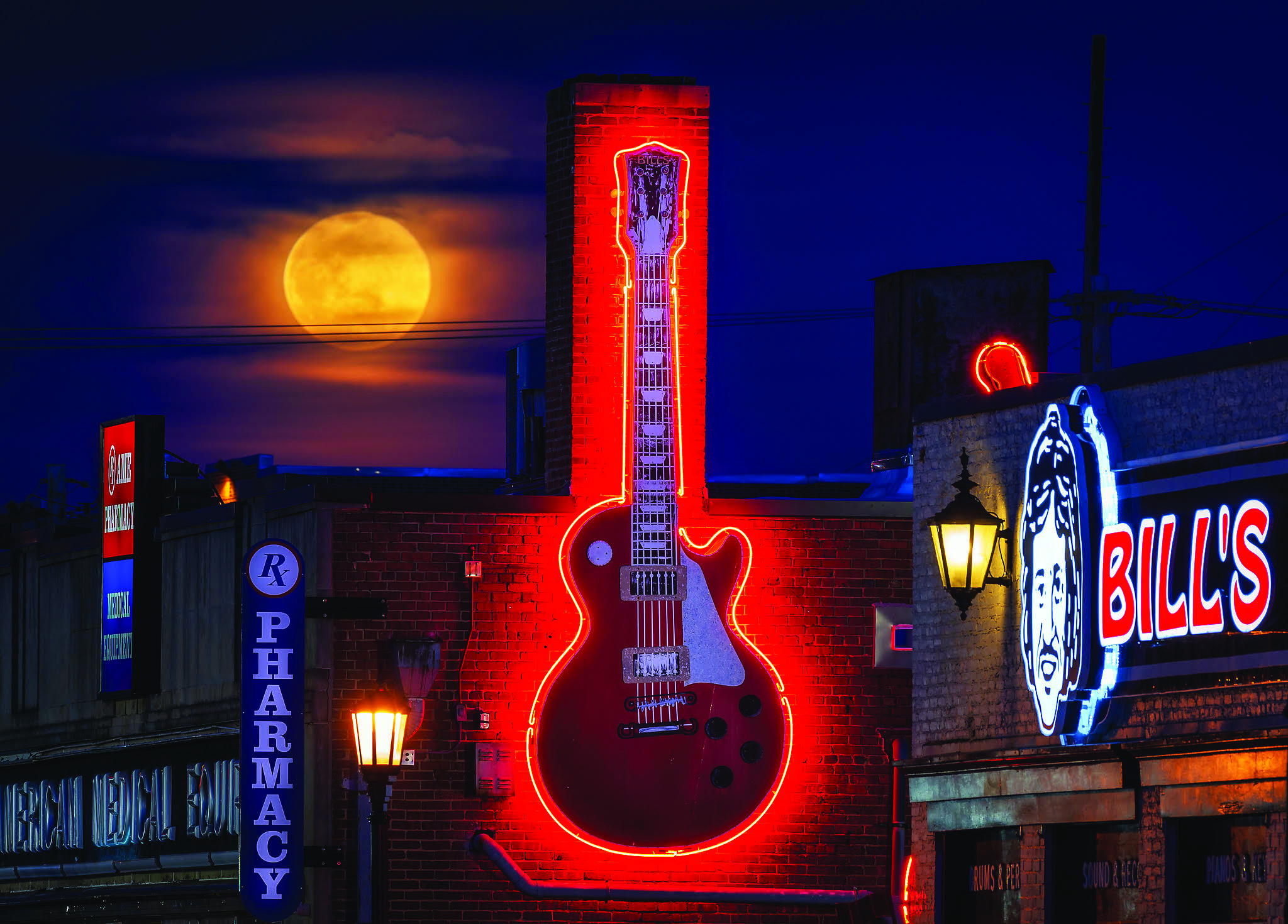 A March full worm moon rises over Bill's Music in Catonsville, Maryland.