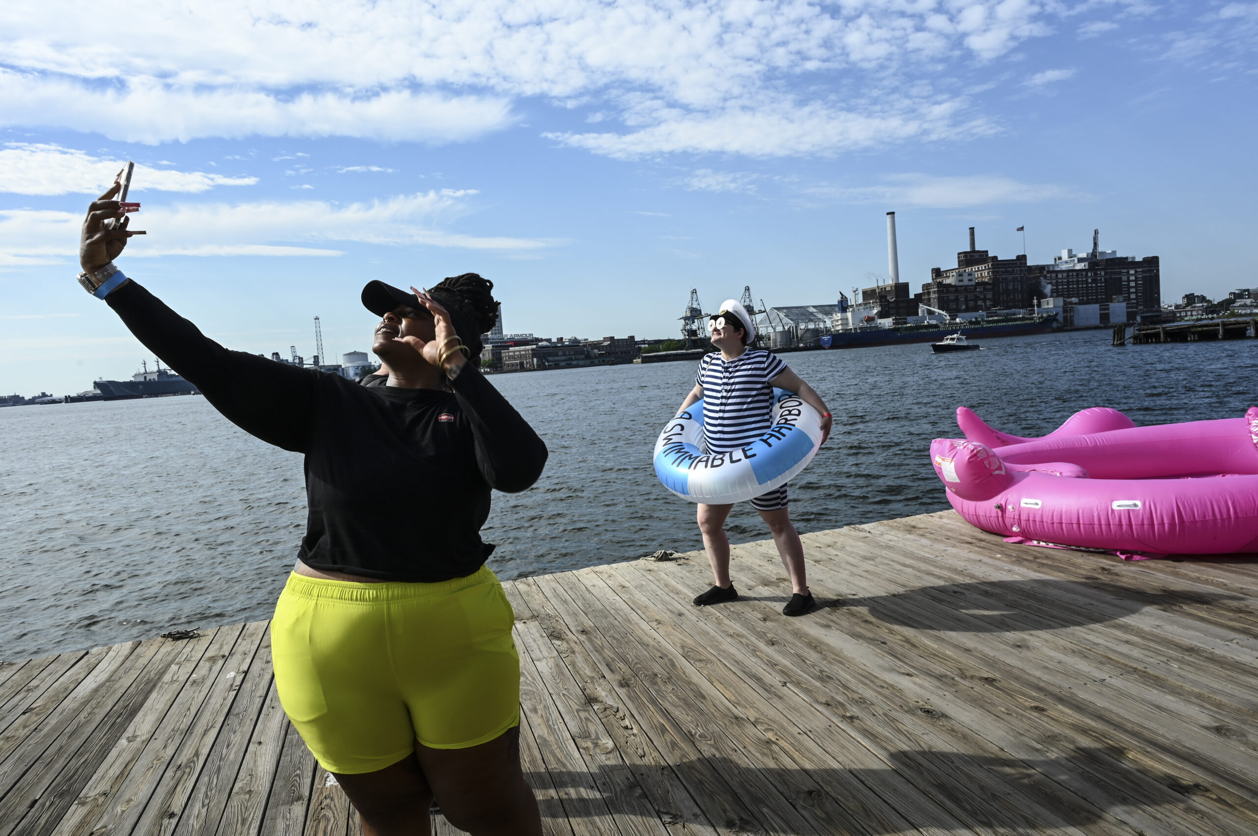 Despite the heat, 150 swimmers partied on Brown's Wharf befor taking the plunge into harbor waters at Fells Point.
