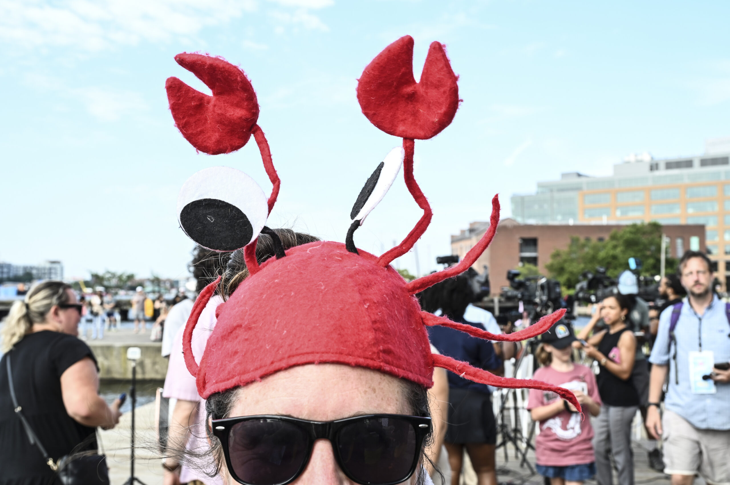 Despite the heat, 150 swimmers partied on Brown's Wharf befor taking the plunge into harbor waters at Fells Point.
