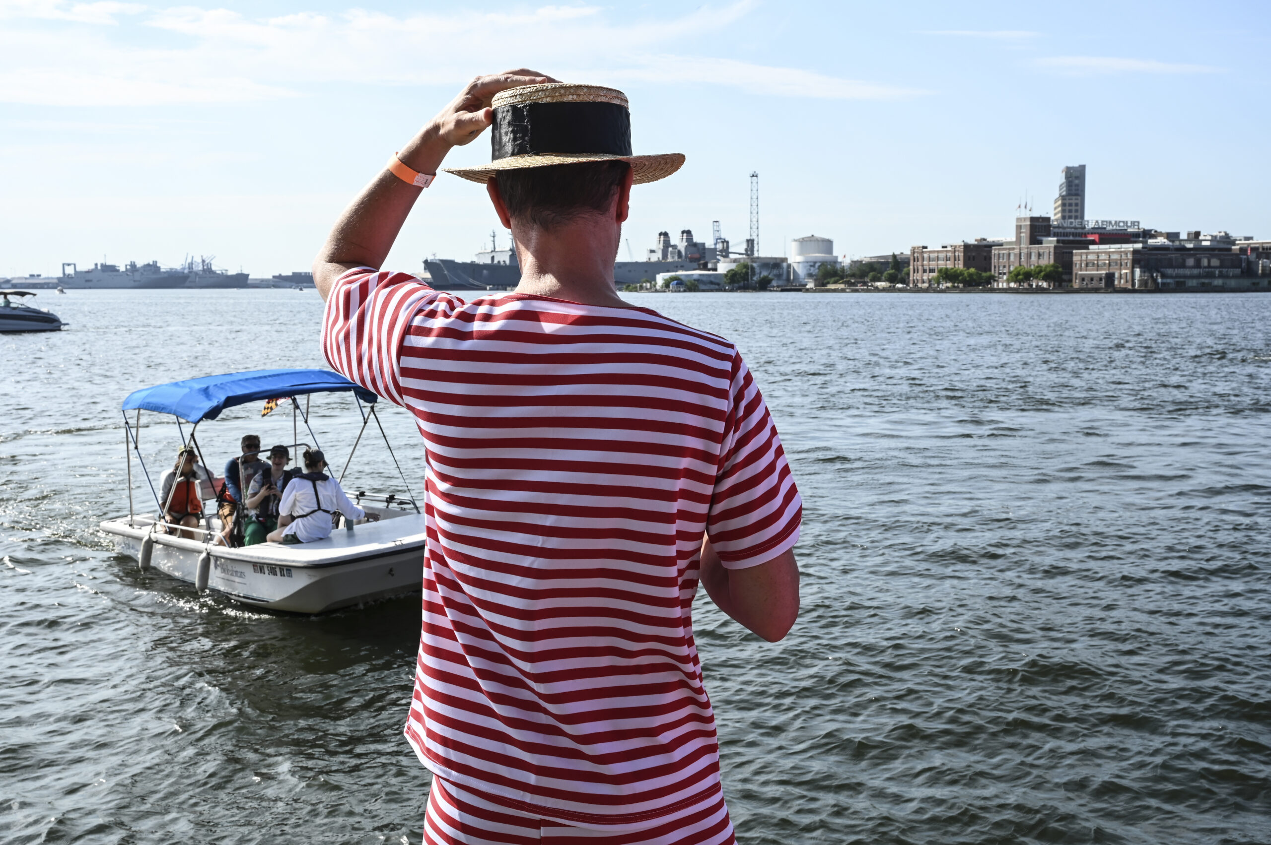 Despite the heat, 150 swimmers partied on Brown's Wharf befor taking the plunge into harbor waters at Fells Point.