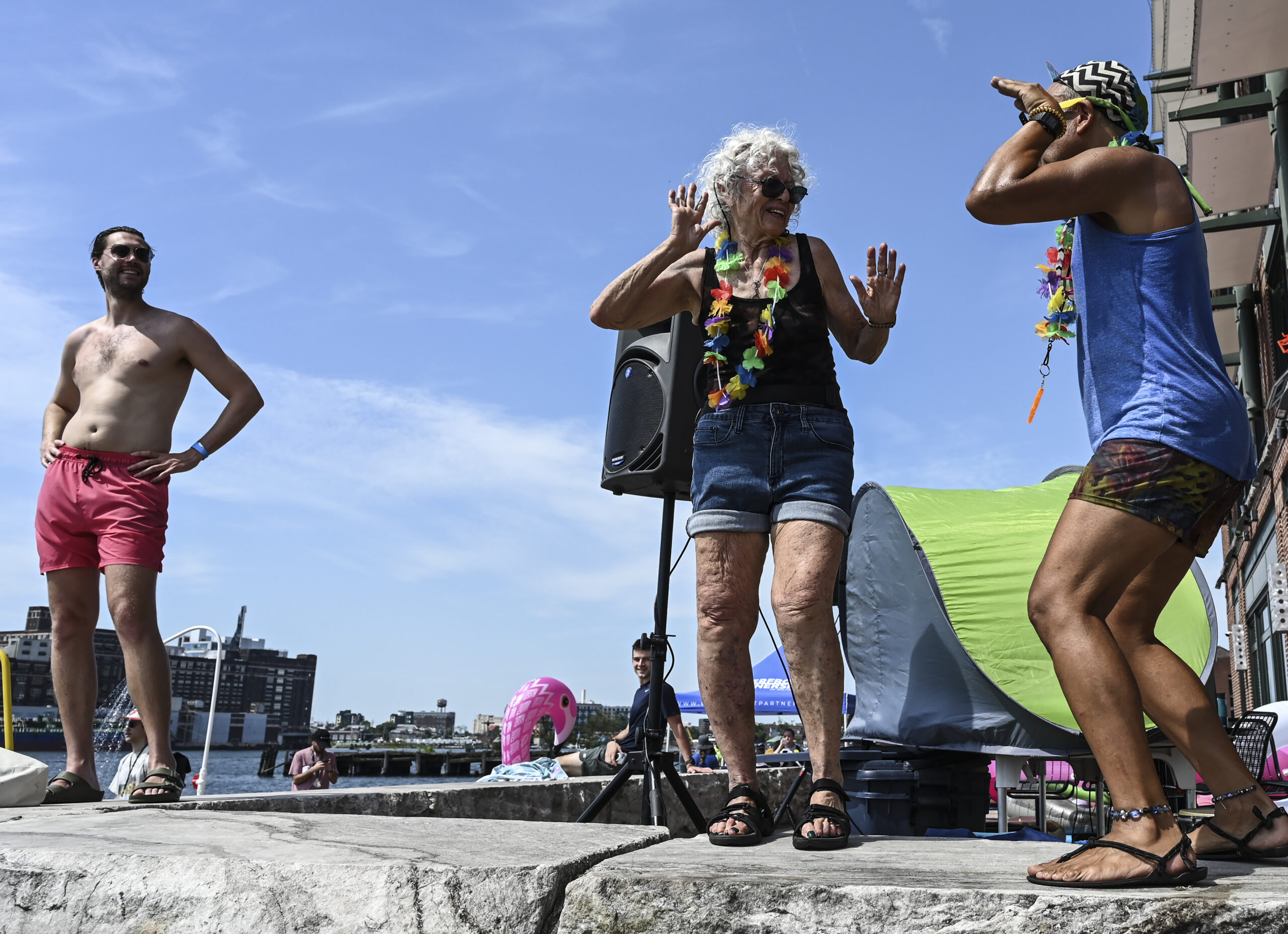 Despite the heat, 150 swimmers partied on Brown's Wharf befor taking the plunge into harbor waters at Fells Point.