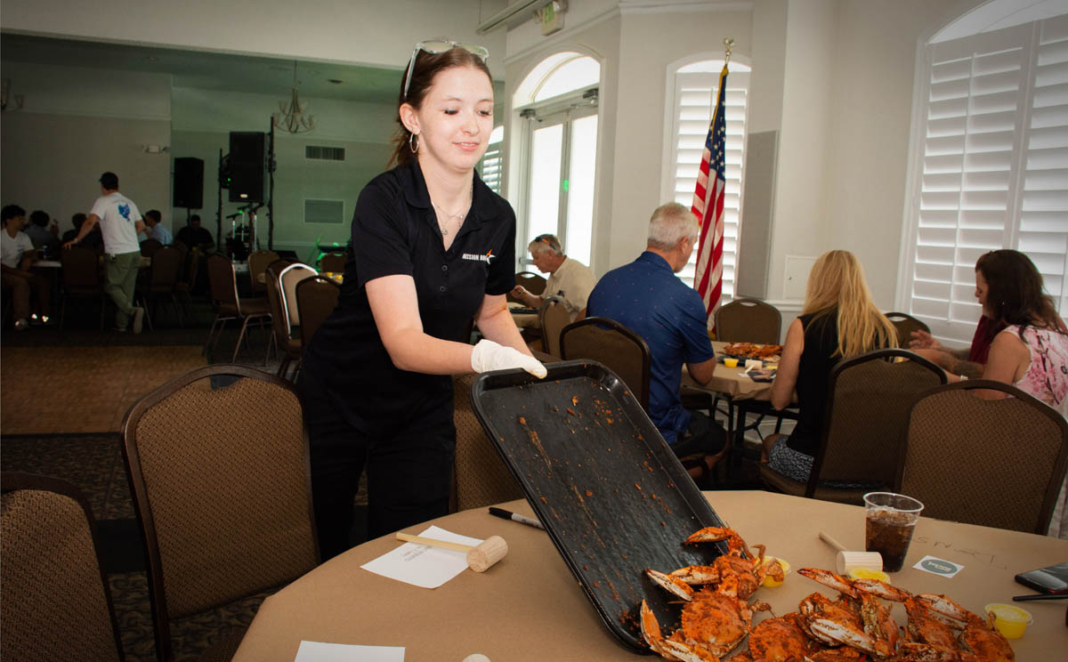 Mission BBQ’s Lauren Wood delivers the goods at the Party’s crabfeast.