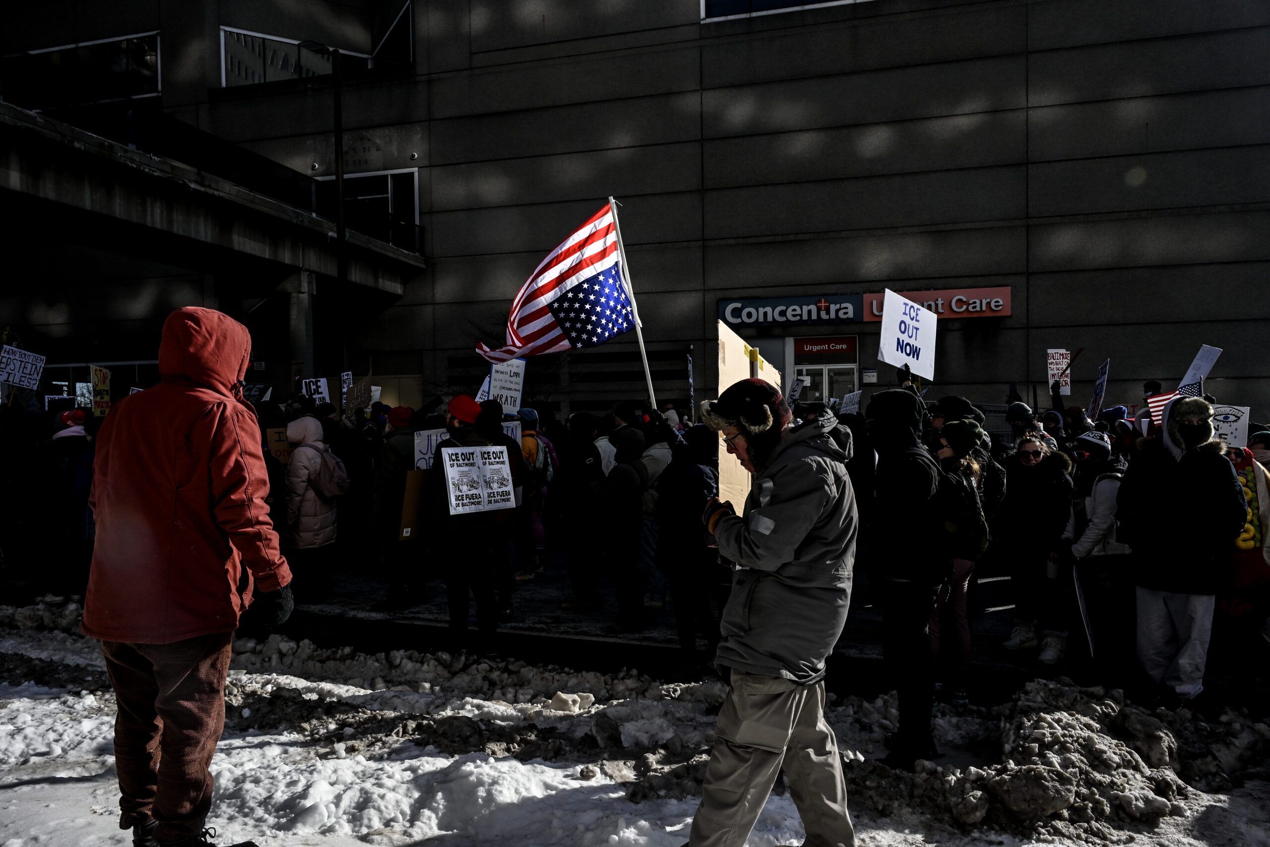 An upside down American flag is seen in a window during an anti-ICE march and Baltimore's participation in a nationwide General Strike.