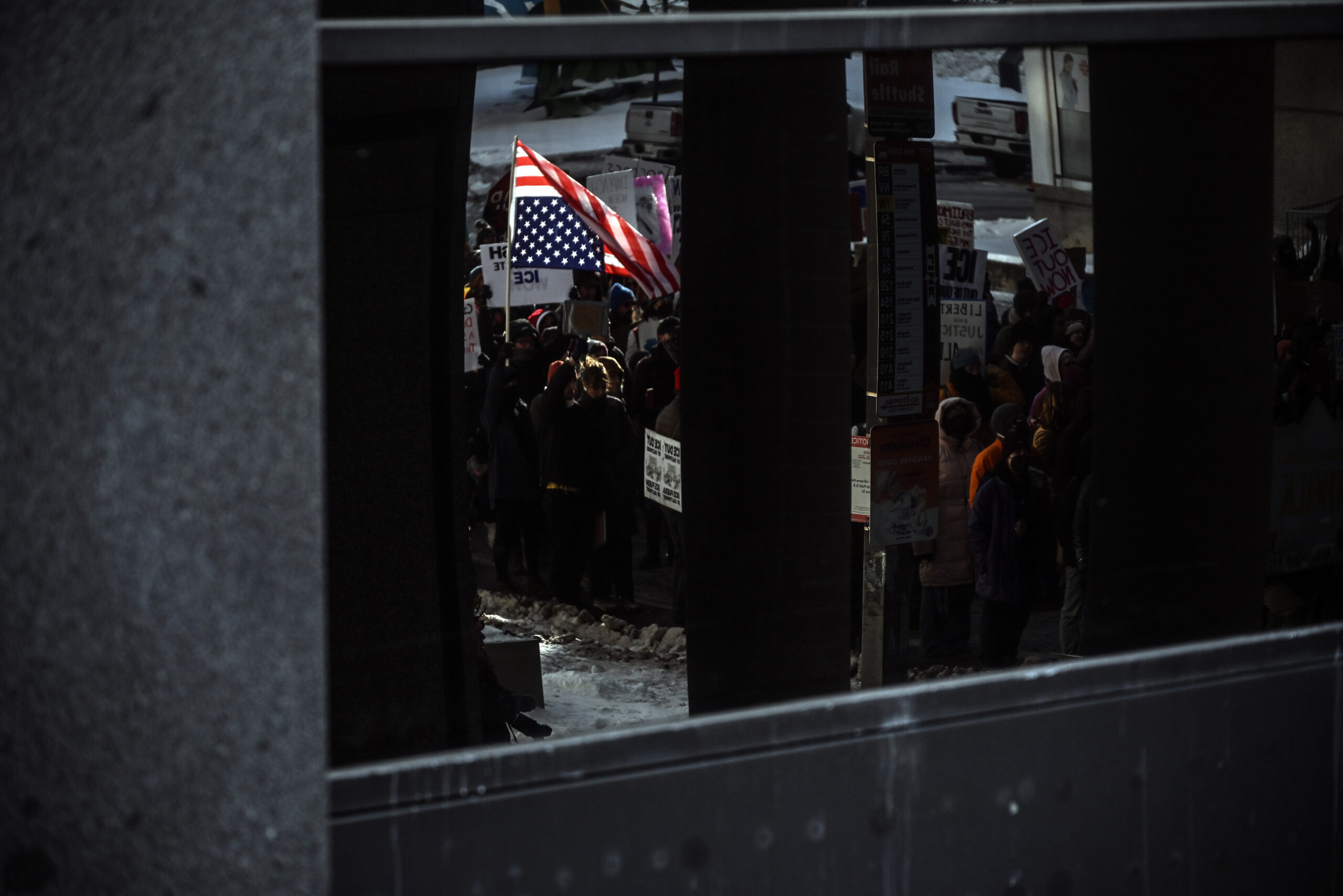 An upside down American flag is seen in an downtown office building reflection duinrg an anti-ICE march and Baltimore's participation in a nationwide General Strike.